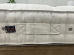 Vispring Baronet Superb 5FT Kingsize mattress with firm spring support, shown in a bedroom setting with bedding and pillows.