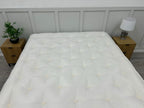 Staples Staples and Co Artisan Pure Decadence 5FT Kingsize mattress with plush fabric and detailed stitching, shown on bed frame.
