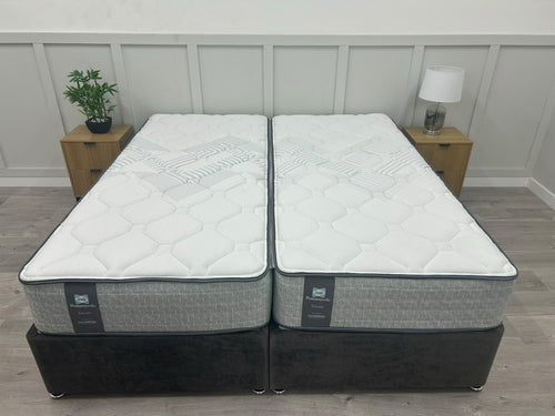 Sealy Newton 6FT Super King zip and link firm mattress with white fabric cover and plush surface, designed for comfort and support.