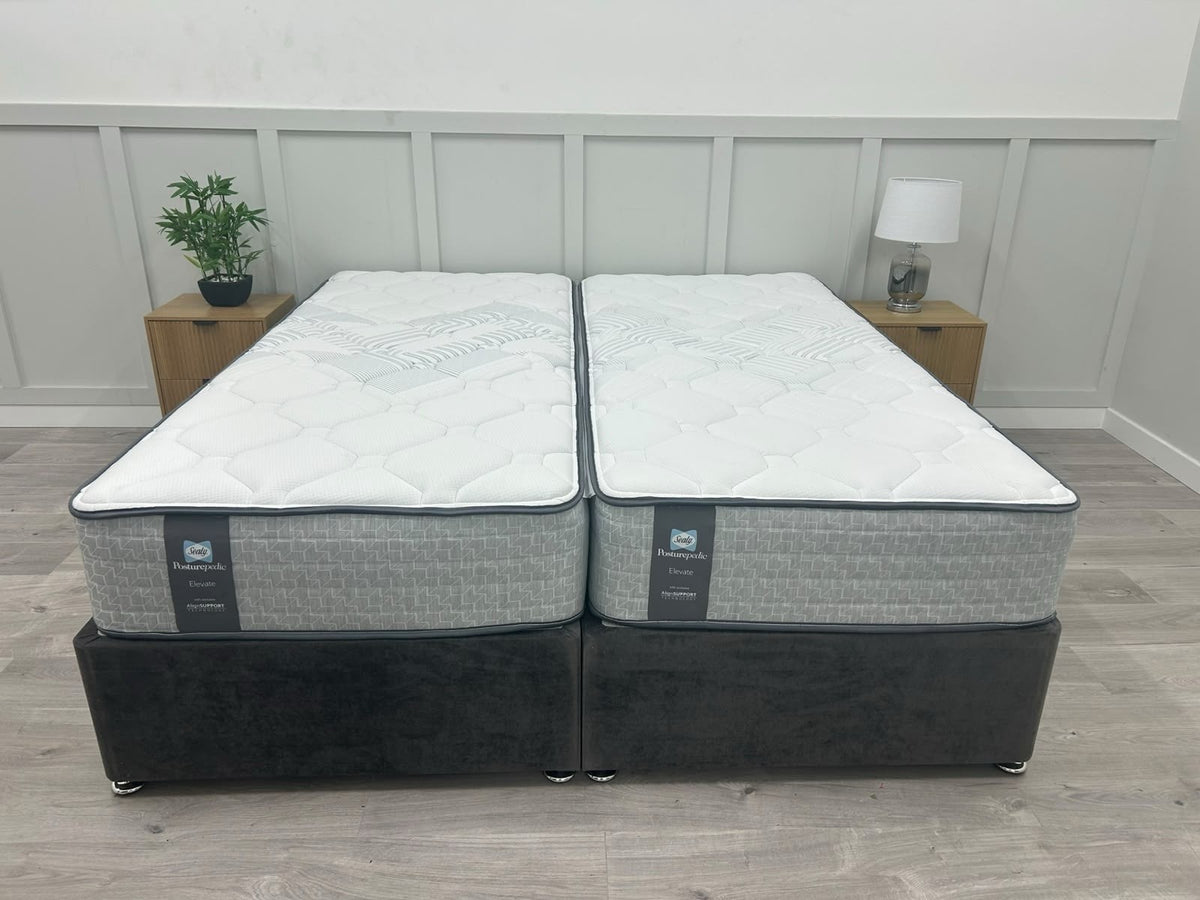 Sealy Newton 6ft Superking zip and link firm mattress with plush fabric cover, designed for comfort and support in a spacious bed frame.