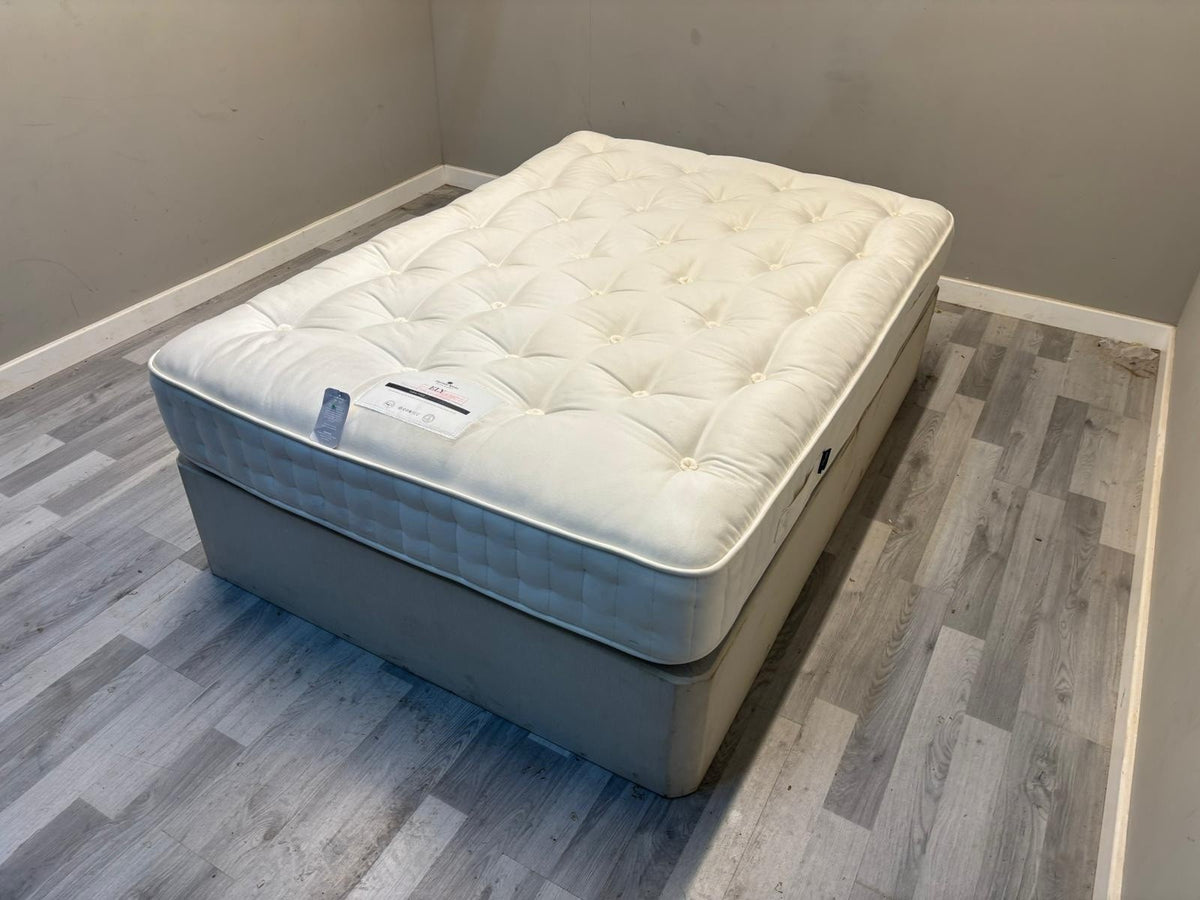 Harrison Spinks 2750 Ely Ortho 4FT 6 double mattress with a firm surface and plush fabric cover, designed for comfortable sleep.