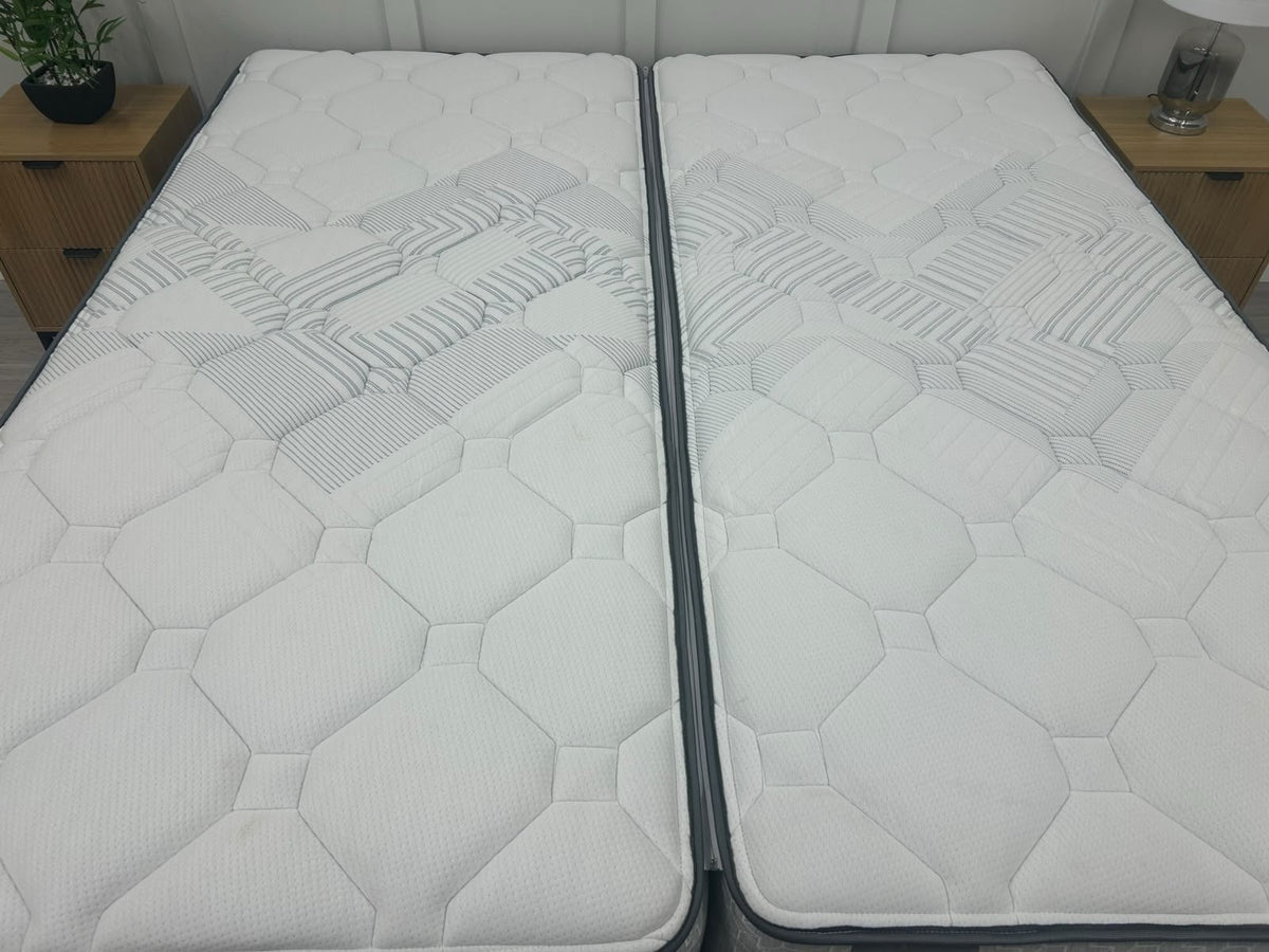 Sealy Newton 6FT Super King zip and link firm mattress with plush fabric cover and visible mattress edges, showcasing a luxurious sleep surface.