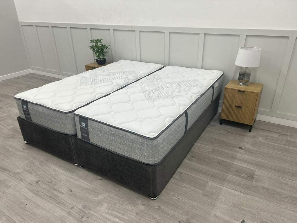 Sealy Newton 6FT Superking zip and link firm mattress with plush fabric cover and visible stitching, designed for comfort and support.