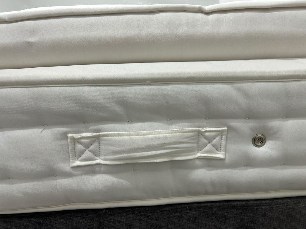 Staples Staples and Co Artisan Pure Decadence 5FT Kingsize mattress with plush top and supportive edges, shown in a bedroom setting.