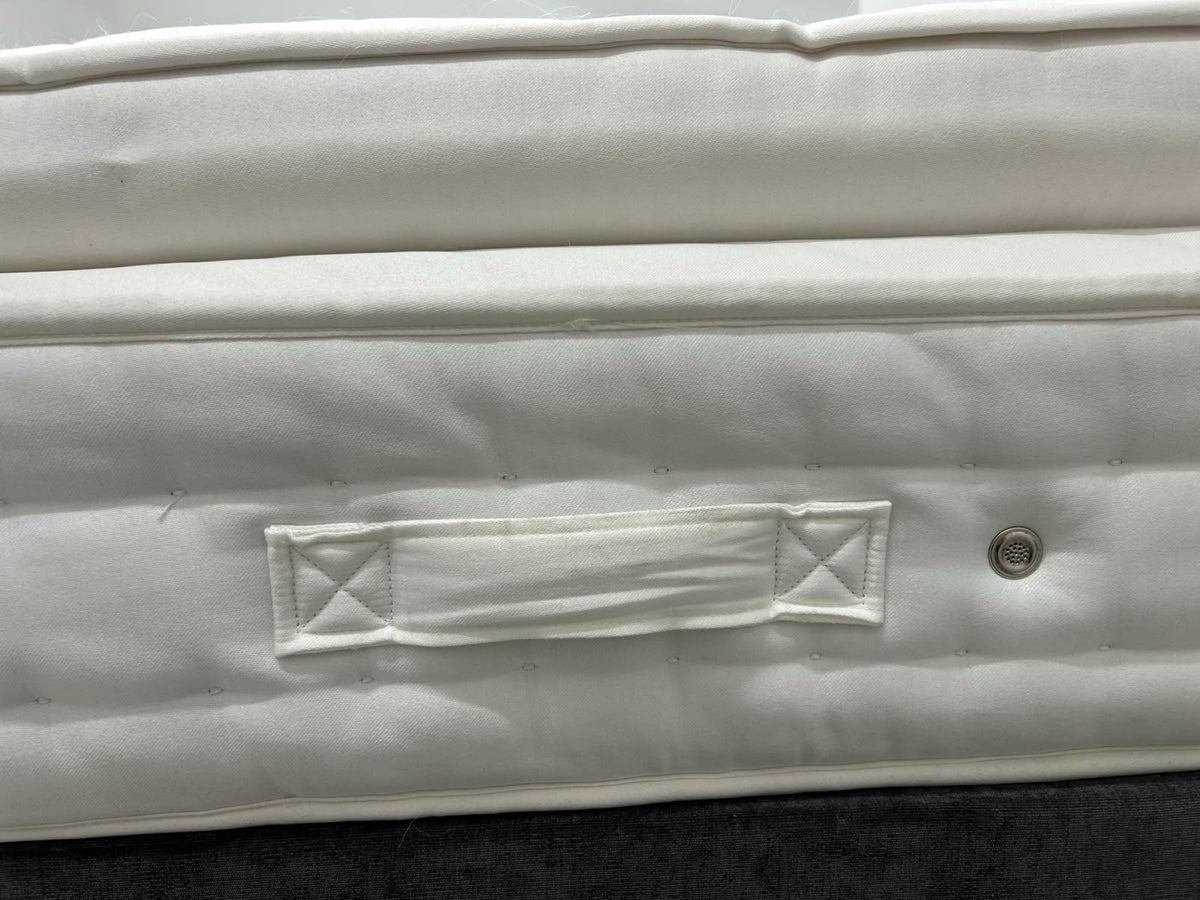 Staples Staples and Co Artisan Pure Decadence 5FT Kingsize mattress with plush top and supportive edges, shown in a bedroom setting.