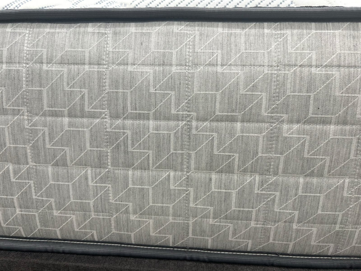 Sealy Newton 6FT Superking firm zip and link mattress with quilted surface and supportive design, shown on a bed frame.