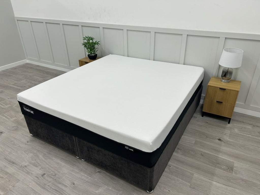 Tempur Pro Luxe Soft 6FT Superking mattress with plush surface, neatly made bed with white bedding and matching pillows.