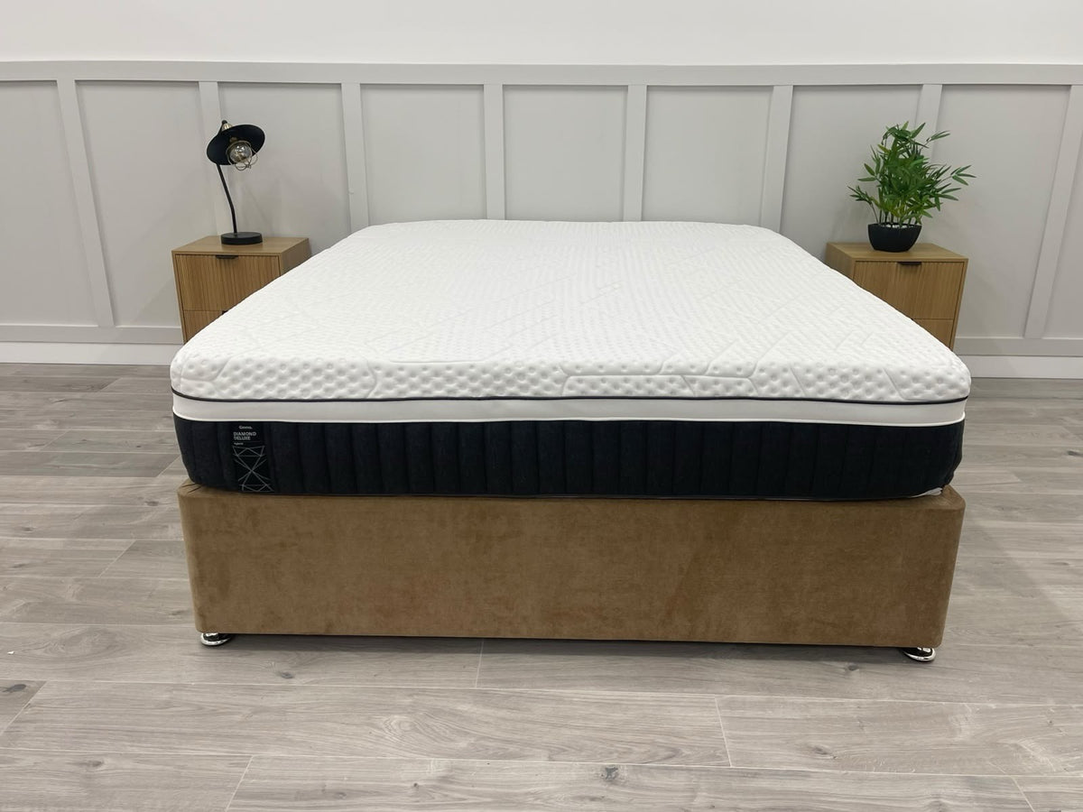 Emma Diamond Deluxe Hybrid 5ft Kingsize mattress with plush top and supportive layers, shown on a bed frame in a modern bedroom.