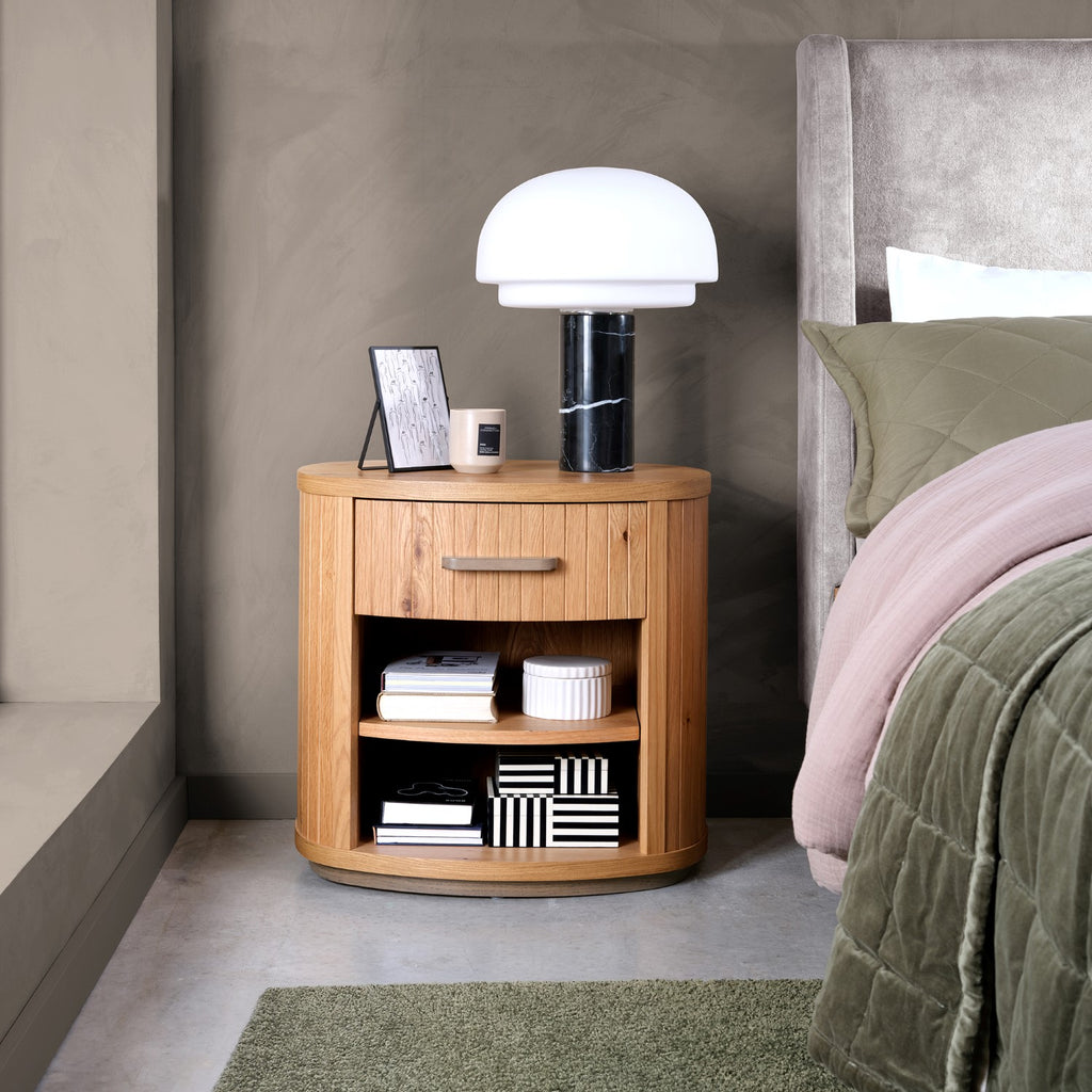 Weathered oak Bentley Designs bedside cabinet with single drawer and curved design, ideal for bedroom storage.