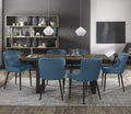 Weathered oak extending dining table with six blue velvet Bentley Designs chairs in a stylish table and chair set.