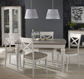 Bentley Designs washed oak extending dining table with four grey leather chairs, showcasing a modern table and chair set.
