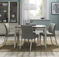 Bentley Designs washed oak dining table set with four grey fabric chairs, modern table and chair set for dining room.