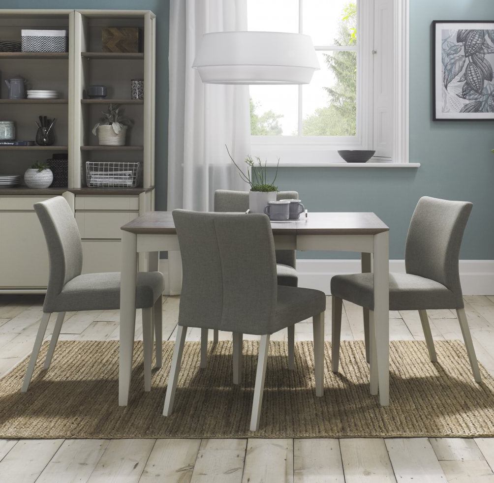 Bentley Designs washed oak dining table set with four grey fabric chairs, modern table and chair set for dining room.