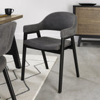 Weathered oak dining table with six grey fabric chairs and two carvers from Bentley Designs in a stylish dining room setting.
