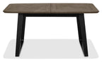 Weathered oak top extending dining table with black metal base by Bentley Designs, showcasing its sturdy construction and modern style.