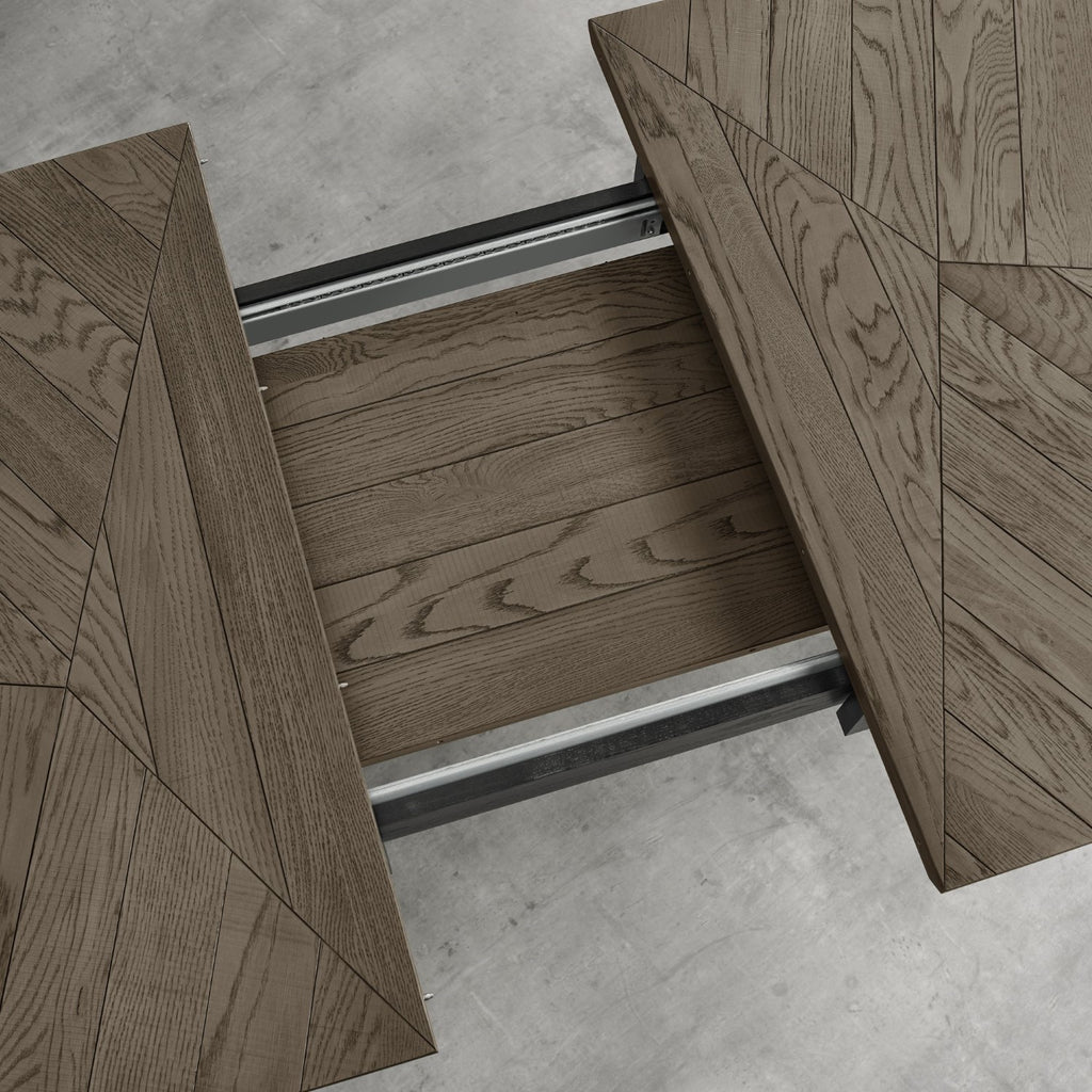 Weathered oak top extending dining table with black metal base by Bentley Designs, showcasing its rustic finish and sleek design.