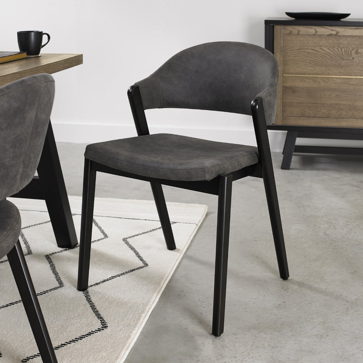 Weathered Oak dining table with six grey fabric chairs and two carvers from Bentley Designs, showcasing a sturdy table and modern seating.