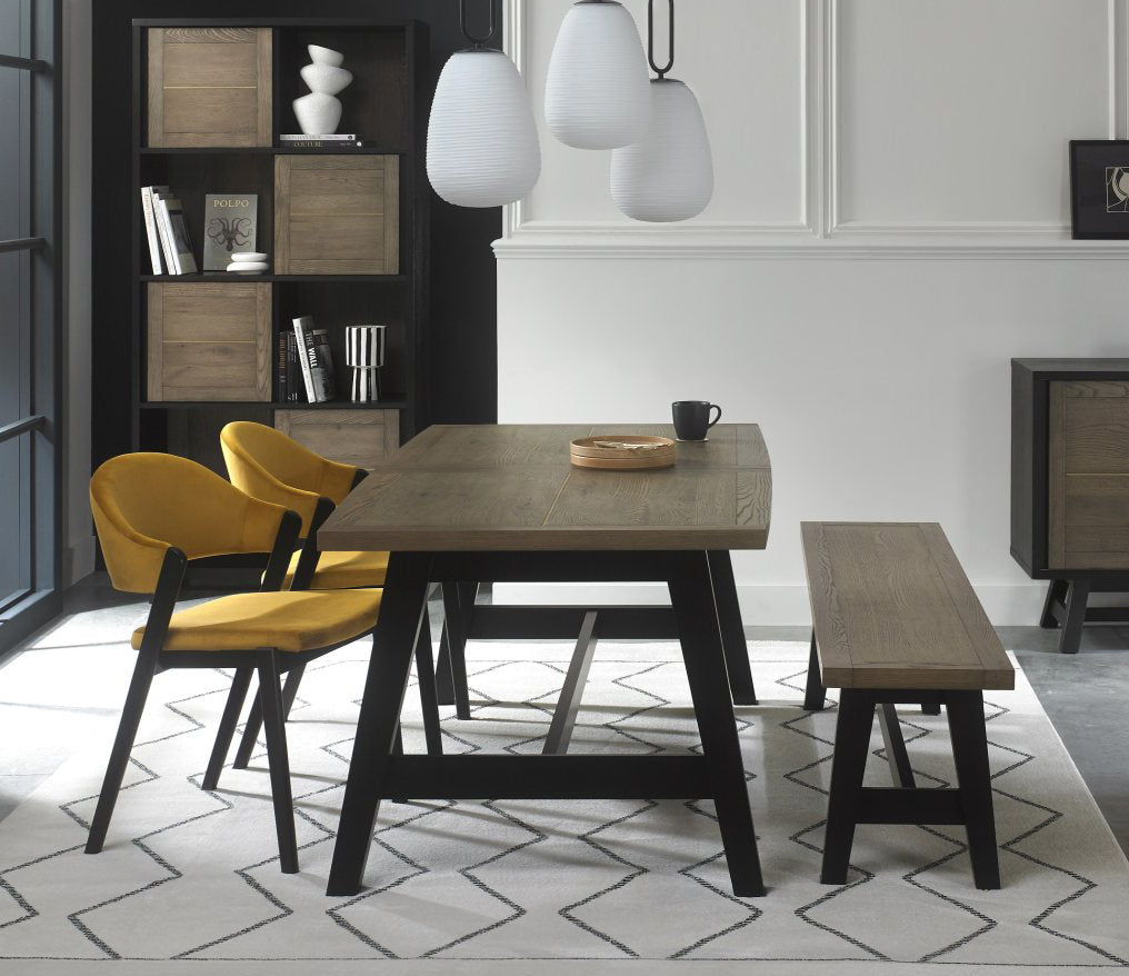 Weathered oak dining set by Bentley Designs with a table, two side chairs, and a matching bench in a rustic style.