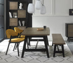 Weathered oak dining set by Bentley Designs with a table, two side chairs, and a matching bench in a rustic style.