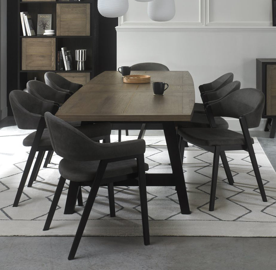 Weathered Oak dining table with six grey fabric chairs and two carver chairs from Bentley Designs, showcasing a stylish table and chair set.