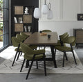 Weathered oak dining table with eight green velvet chairs by Bentley Designs, showcasing a stylish table and chair set.