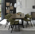 Weathered oak dining table with eight green velvet chairs by Bentley Designs, showcasing a stylish table and chair set.