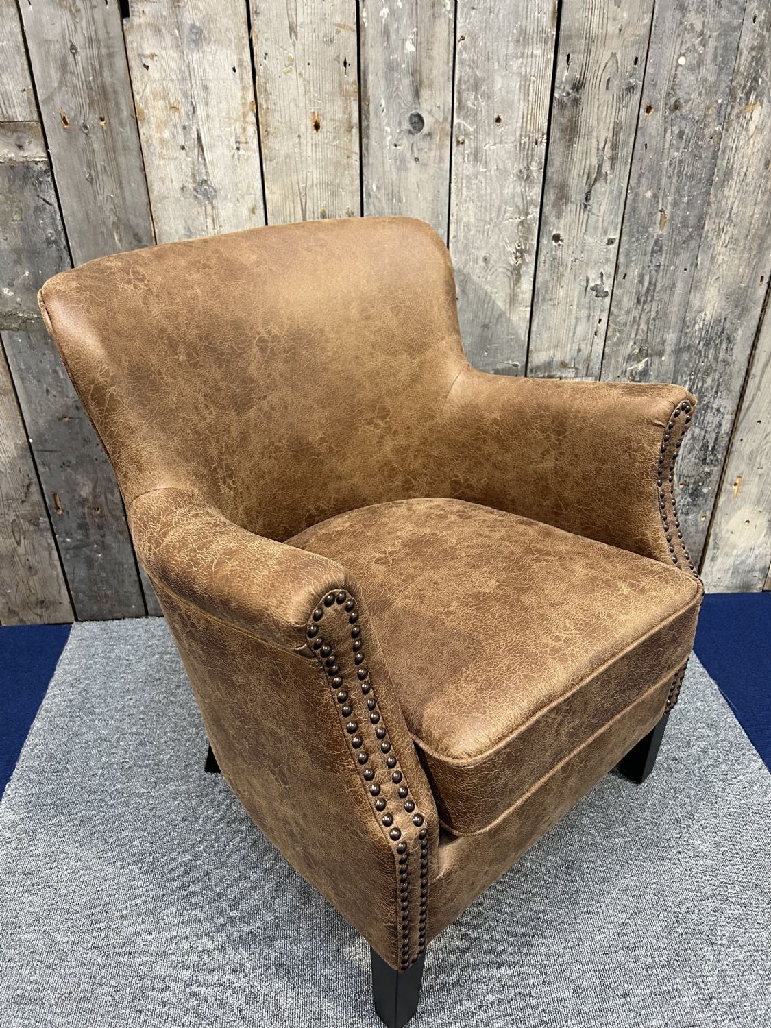 Vintage Style Brown Leather Lounge Armchair with Stud Detailing and Curved Back