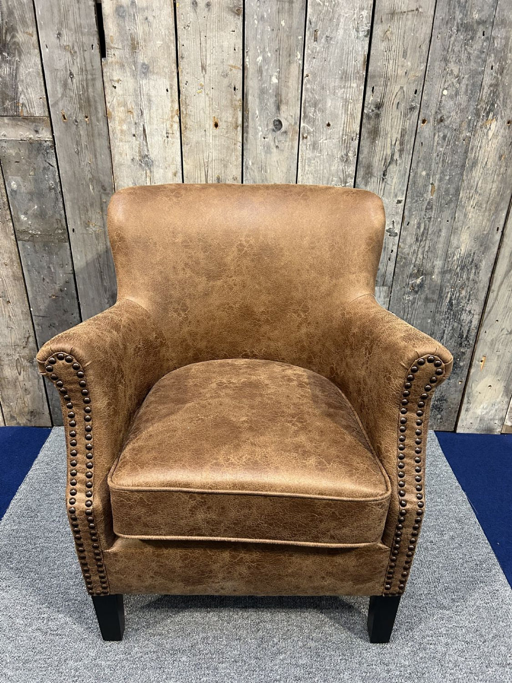 Vintage Style Brown Leather Lounge Armchair with Stud Detailing and Curved Back - Home Furniture Interiors