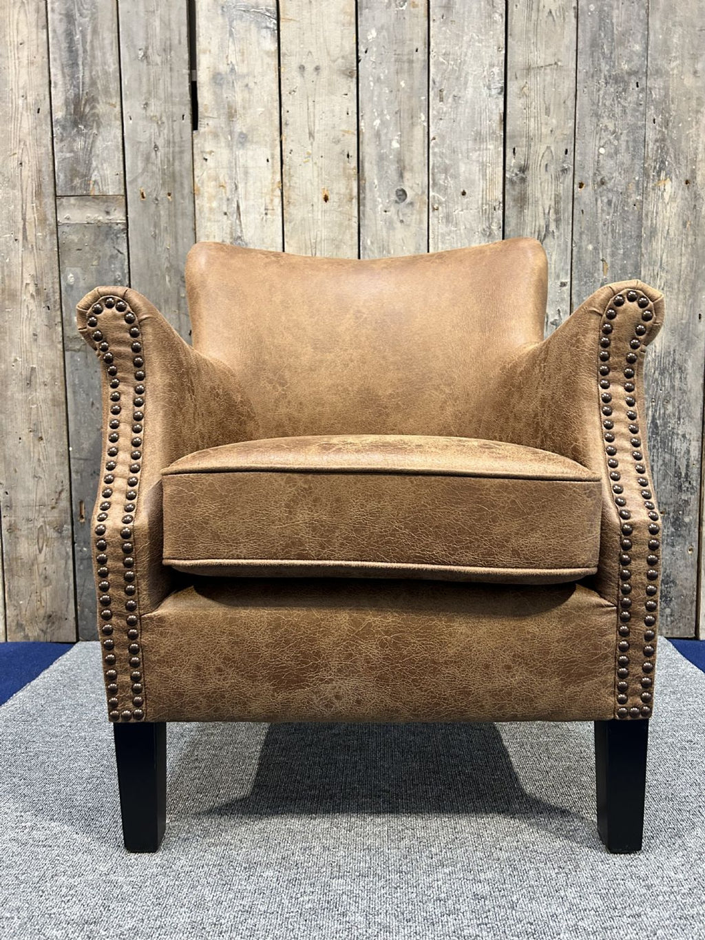 Vintage Style Brown Leather Lounge Armchair with Stud Detailing and Curved Back - Home Furniture Interiors