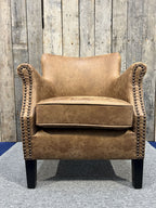 Vintage Style Brown Leather Lounge Armchair with Stud Detailing and Curved Back - Home Furniture Interiors