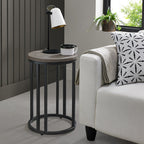 Silver grey wooden round side table with black metal base, ideal for living room or bedroom as a stylish end table.