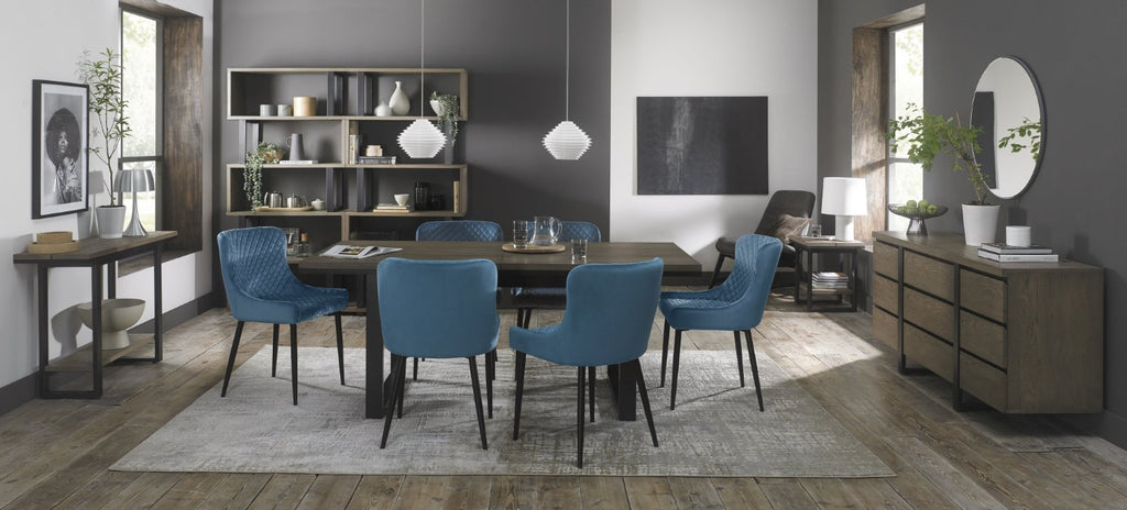 Weathered Oak extending dining table with six blue velvet Bentley Designs chairs in a stylish table and chair set.