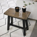 Weathered dark oak Bentley Designs side lamp table with black legs, featuring a rustic finish and compact end table design.