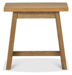 Rustic oak side table by Bentley Designs with a traditional style, featuring a smooth wooden surface and sturdy legs.