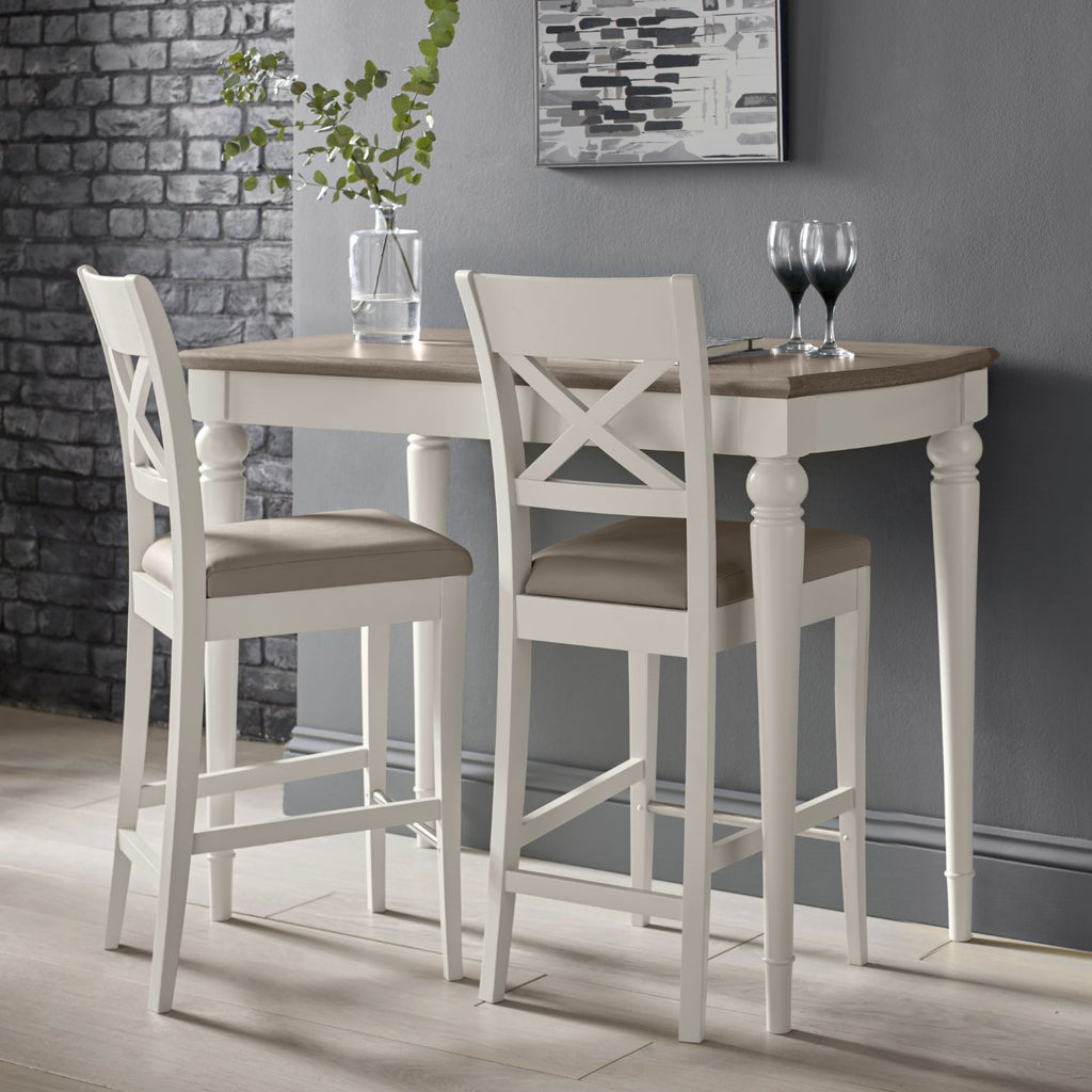 Bentley Designs washed oak bar table with two grey leather bar stools in a stylish table and chair set.
