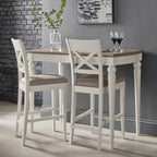 Bentley Designs washed oak bar table with two grey leather bar stools in a stylish table and chair set.