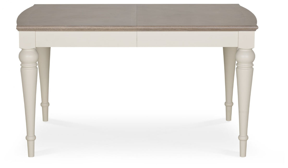 Washed oak extending dining table with four grey leather chairs, Bentley Designs table and chair set in a modern dining space.