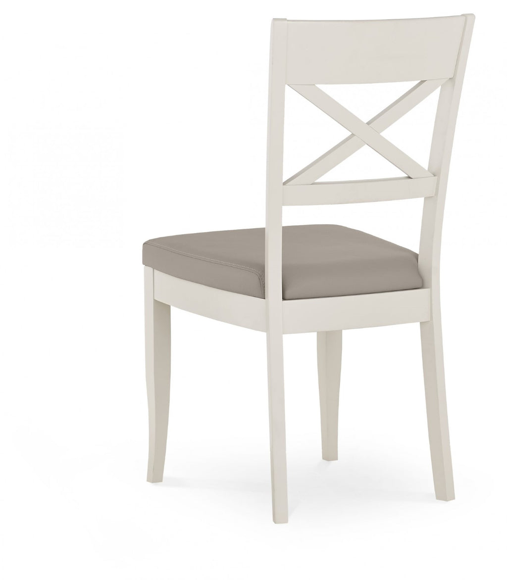 Bentley Designs washed oak extending dining table with four grey leather chairs, modern table and chair set for dining room.