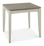 Bentley Designs washed oak dining table set with four grey fabric chairs, showcasing a modern, rustic table and comfortable seating.