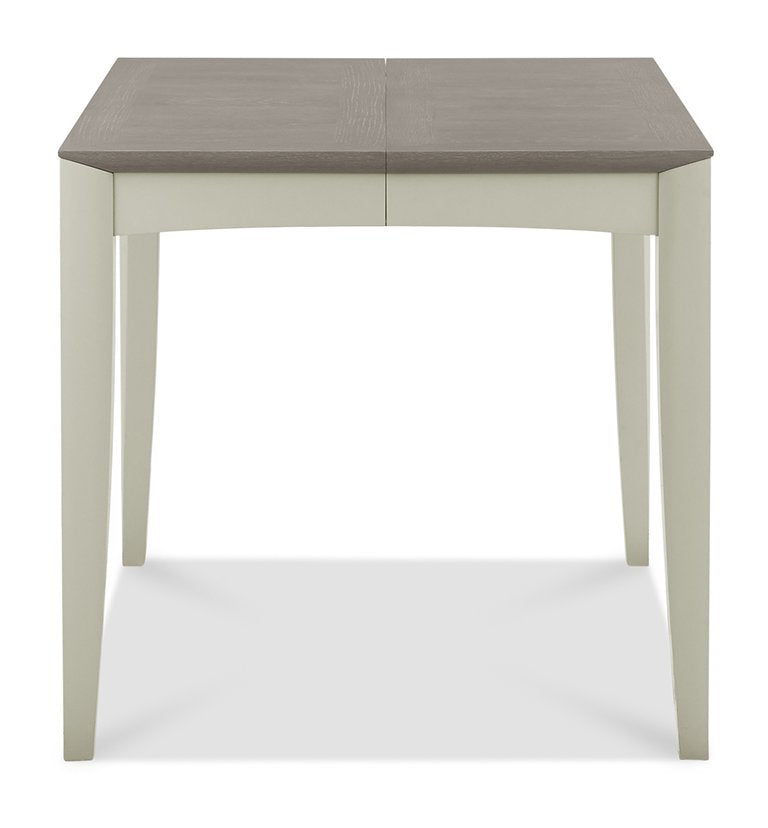 Bentley Designs washed oak dining table set with four grey fabric chairs, modern table and chair set for dining rooms.