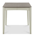 Bentley Designs washed oak dining table set with four grey fabric chairs, modern table and chair set for dining rooms.