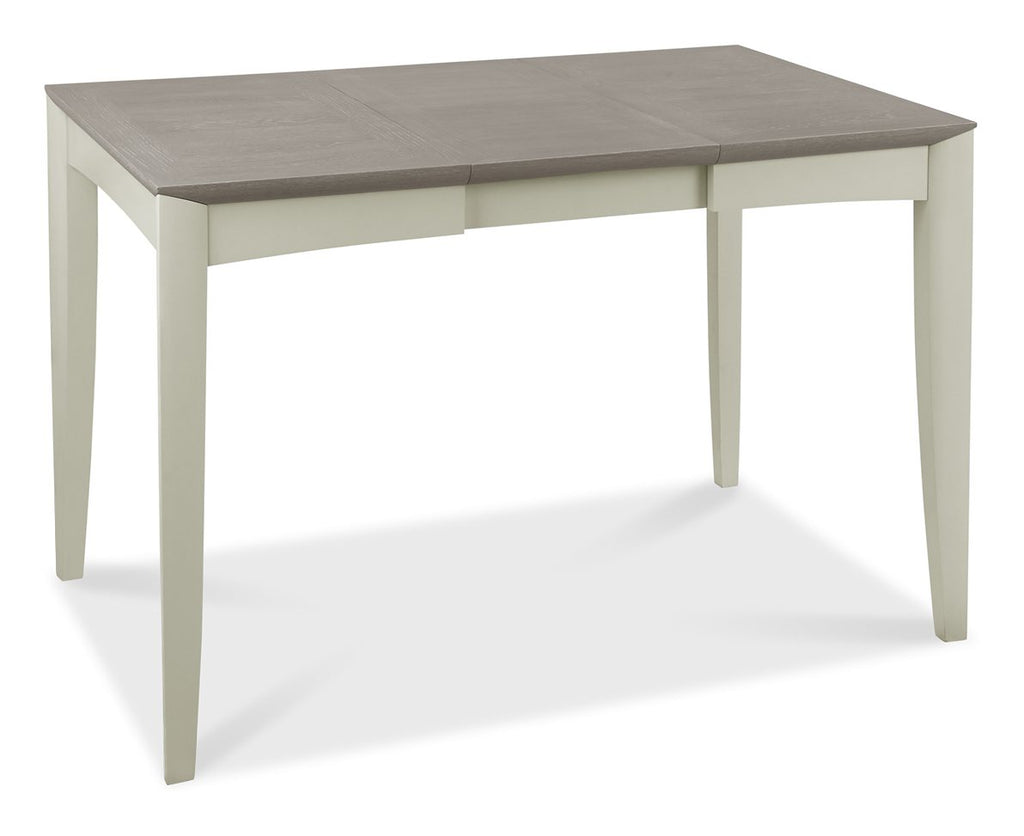 Bentley Designs washed oak dining table set with four grey fabric chairs, showcasing a modern and sturdy table and chair arrangement.