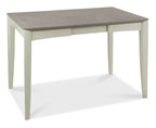 Bentley Designs washed oak dining table set with four grey fabric chairs, showcasing a modern and sturdy table and chair arrangement.