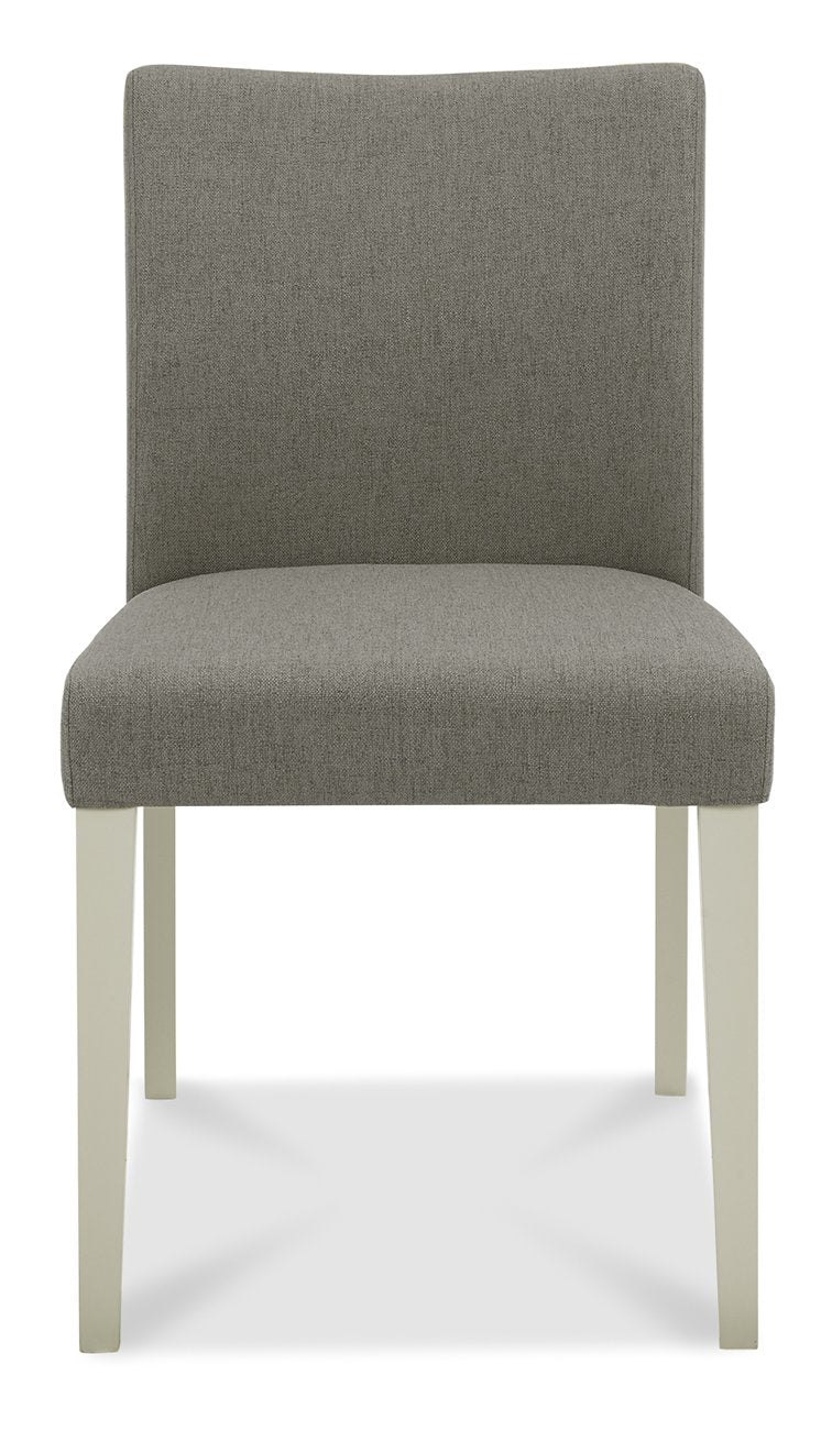Bentley Designs washed oak dining table with four grey fabric upholstered chairs, modern table and chair set for dining room.