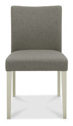 Bentley Designs washed oak dining table with four grey fabric upholstered chairs, modern table and chair set for dining room.