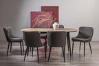 Weathered oak rectangular dining table with six grey leather chairs from Bentley Designs dining set.