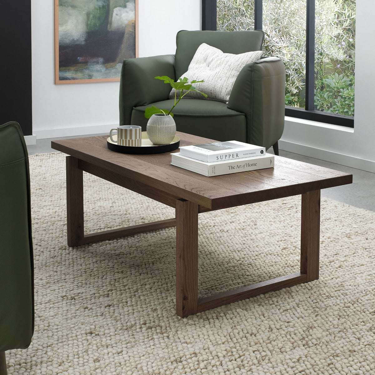 Dark oak Bentley Designs coffee table with wire brushed finish, featuring a sleek, modern wooden surface and sturdy legs.
