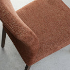 Pair of Auburn Brown Bentley Designs fabric dining chairs with dark oak legs, showcasing plush upholstery and sleek wooden legs.