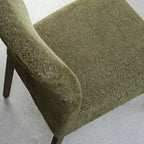 Pair of green fabric dining chairs with dark oak legs by Bentley Designs, showing the upholstered seats and wooden frames.