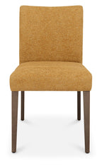 Pair of mustard yellow fabric dining chairs with dark oak legs by Bentley Designs, showing a close-up of the upholstered seats and wooden legs.